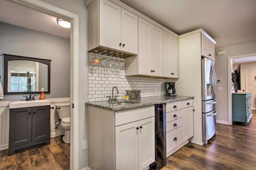 a kitchen with white cabinets and a sink at Modern Home with Yard and Deck, 1 Mi to Clemson U! in Clemson