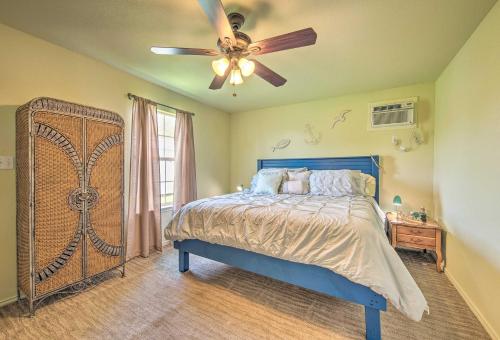 a bedroom with a bed and a ceiling fan at Half-Mi to Seadrift Harbor Seadrift Home with Deck in Seadrift