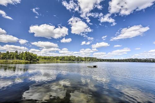 a view of a lake with a bench in the water at Rustic Hayward Cabin With Spider Lake Access! in Seeley