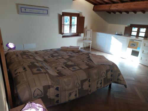 a bedroom with a bed with a blanket on it at Il Mulino di Celle in Pistoia