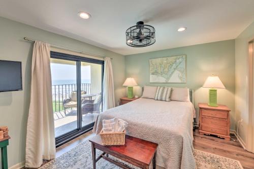 a bedroom with a bed and a balcony at Atlantic Beach Resort Condo with Ocean Views! in Atlantic Beach