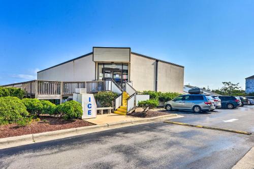 a building with a car parked in a parking lot at Summer Winds Resort Condo with Ocean Views! in Atlantic Beach