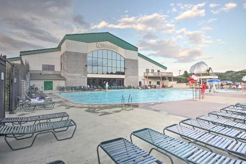 a swimming pool with blue chairs in front of a building at Resort Home on Mountain Golf Course with Deck and View in McGaheysville
