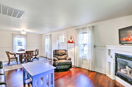 a living room with a fireplace and a chair and a table at Ferndale Cottage on Private 20 Acre Farm! in Ferndale