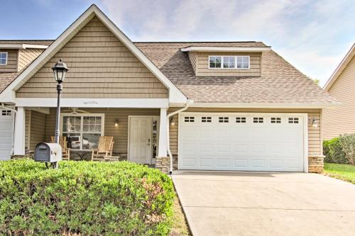a house with a driveway and a garage at Home with Community Pool - 2 Miles to The Island! in Pigeon Forge