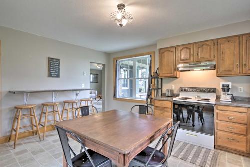 a kitchen with a wooden table and a dining room at Pet-Friendly Spring Grove Home with Serene Yard! in Caledonia