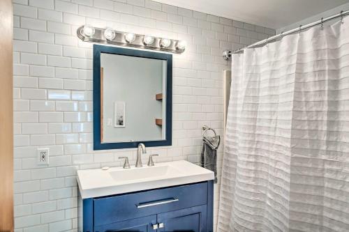 a bathroom with a blue sink and a mirror at Hood Canal Home with Hot Tub - Bordering Olympic NP! in Brinnon