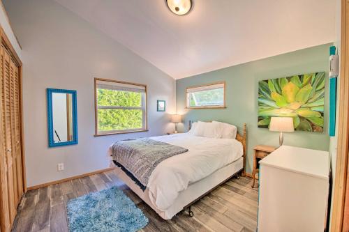 a bedroom with a bed and a painting on the wall at Hood Canal Home with Hot Tub - Bordering Olympic NP! in Brinnon