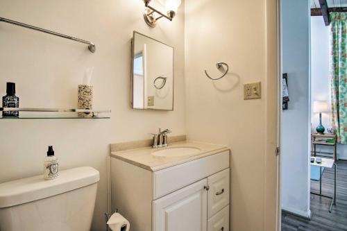 a bathroom with a toilet and a sink and a mirror at Walk to Dewey Beach Bright Condo with Balcony! in Dewey Beach