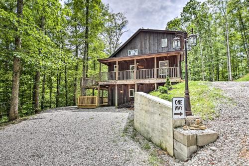 a large wooden house in the middle of the forest at Hike and Zip-Line Red River Gorge Cabin with Hot Tub! in Rogers