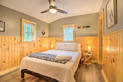 a bedroom with a bed and a ceiling fan at Hike and Zip-Line Red River Gorge Cabin with Hot Tub! in Rogers