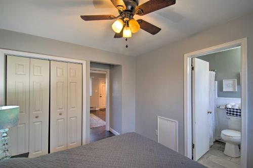 1 dormitorio con ventilador de techo y baño en Ira Township Apt with Dock on Lake St Clair!, en Chesterfield