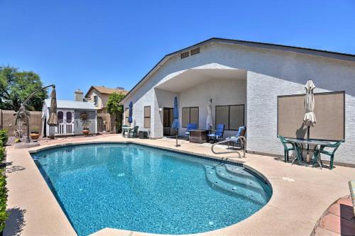 a swimming pool in front of a house at Walk to NFL Games Glendale Home Near Golf in Glendale