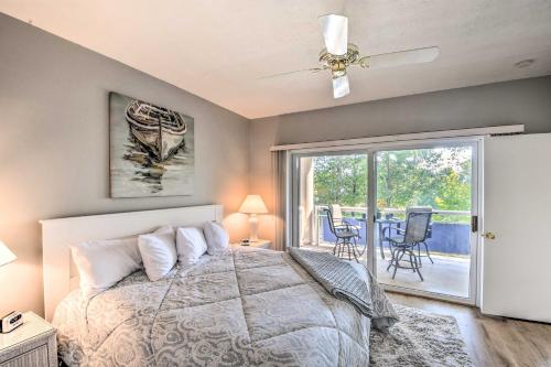 a bedroom with a bed and a sliding glass door at Lake Keowee Condo with Views and Pools and Marina! in Salem
