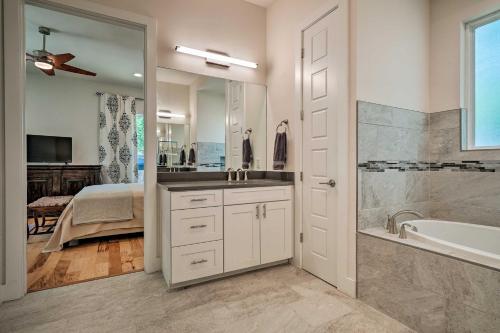 a bathroom with a sink and a tub and a bed at Walk to Lake Austin Spacious Getaway with Patio in Austin