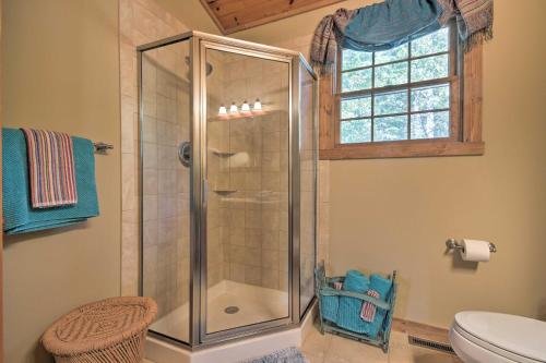 a bathroom with a shower with a toilet and a window at Couples Cabin - 5 Mi to DT Berkeley Springs! in Berkeley Springs