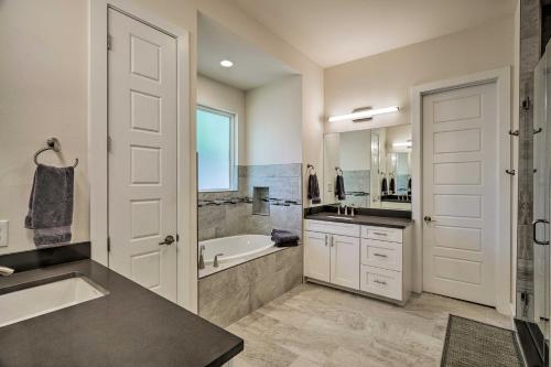 a bathroom with a tub and a sink and a toilet at Walk to Lake Austin Spacious Getaway with Patio in Austin