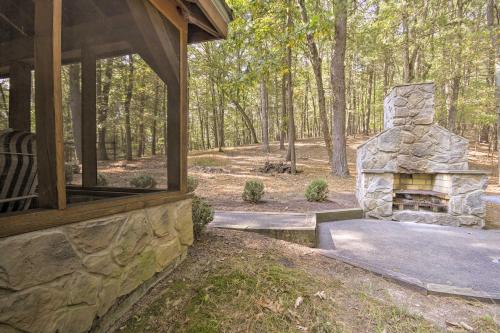 a stone fireplace outside of a house with a porch at Couples Cabin - 5 Mi to DT Berkeley Springs! in Berkeley Springs