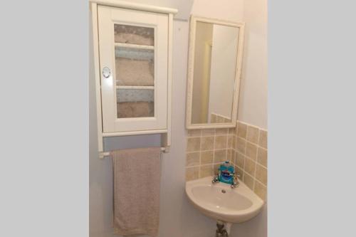 a bathroom with a sink and a mirror at Lavender House in Edwinstowe