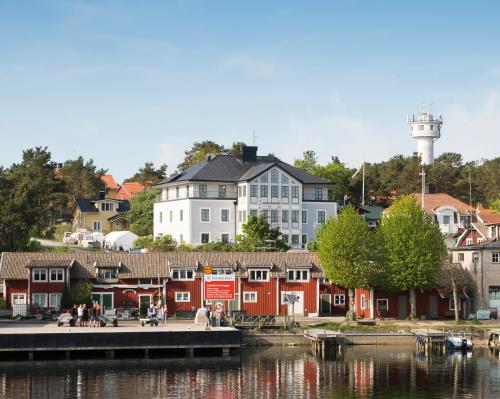a group of buildings next to a body of water at Sands Hotell in Sandhamn