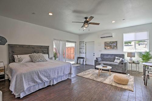 a bedroom with a bed and a couch and a ceiling fan at Cottage by the Lakes with Hot Tub by Lake Nacimiento in Oak Shores