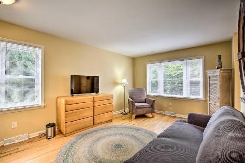 a living room with a couch and a television at Kansas City Apt, Walk to KC MuseumandMed School in Kansas City