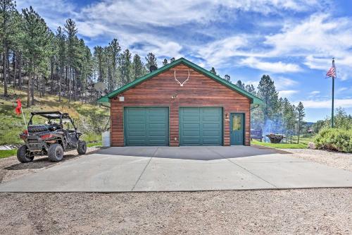 a small house with a atv parked in front of it at Black Hills Cabin Hot Tub, Fishing Pond and Deck in Custer
