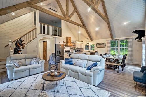 a large living room with two couches and a kitchen at Benezette Cabin with Hot Tub, Grill and Mtn Views in Benezette