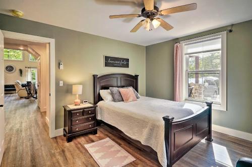 a bedroom with a bed and a ceiling fan at Benezette Cabin with Hot Tub, Grill and Mtn Views in Benezette