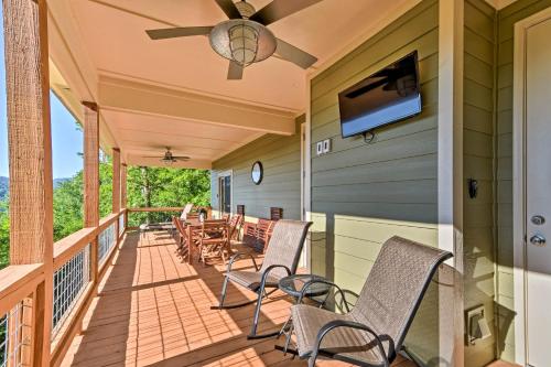 a porch with chairs and a flat screen tv at Hiawassee Home with Views Less Than 1 Mi to Lake Chatuge in Hiawassee