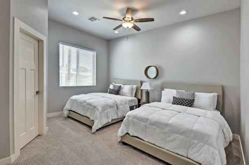 a bedroom with two beds and a ceiling fan at 7 Mi to Dtwn Phoenix Home with Patio and Yard in Phoenix