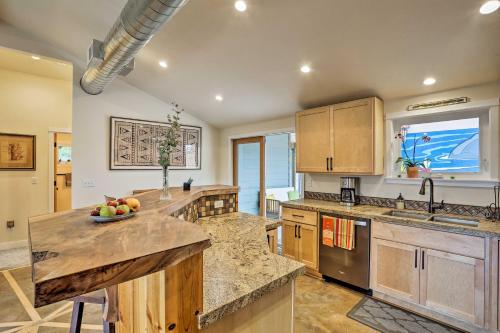 a kitchen with wooden cabinets and a bowl of fruit on the counter at Coastal Soul Arcata Area California Home in Blue Lake