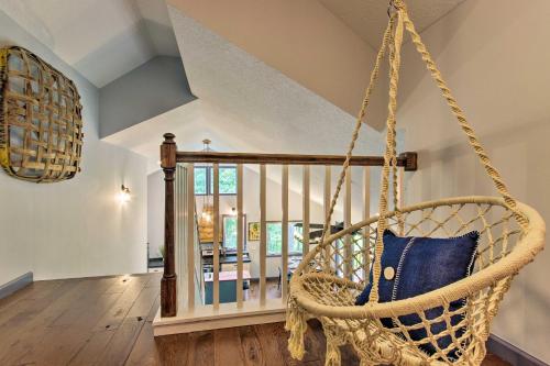 a swinging chair in a room with a staircase at Home with Deck and Game Room - 8 Mi to Asheville in Fairview