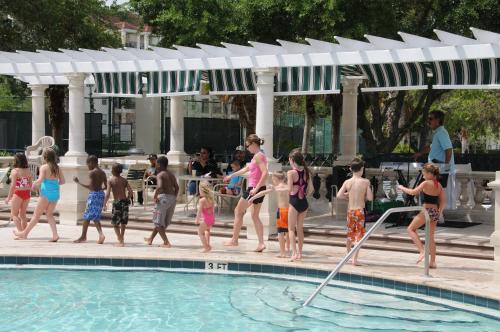 a group of people standing around a swimming pool at Star Island Resort and Club - Near Disney in Kissimmee