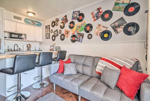 a living room with a couch and records on the wall at Beachfront Corpus Christi Condo with Arcade Room! in Corpus Christi