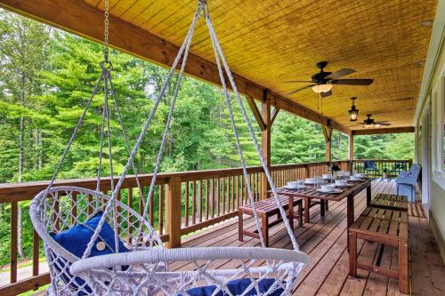 a porch with swings and a table and chairs at Home with Deck and Game Room - 8 Mi to Asheville in Fairview