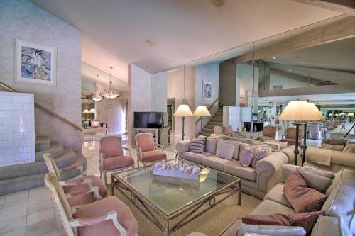 a large living room with couches and chairs at Luxury Home with Pool and Spa - 3 Mi to Natl Park! in Rancho Mirage