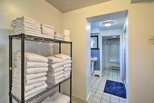a bathroom with a stack of towels on a shelf at Algoma Lake Retreat with BBQ Grill, Yard and Fire Pit! in Algoma