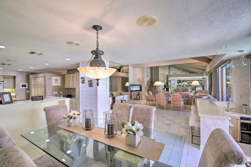 a dining room and kitchen with a glass table and chairs at Luxury Home with Pool and Spa - 3 Mi to Natl Park! in Rancho Mirage