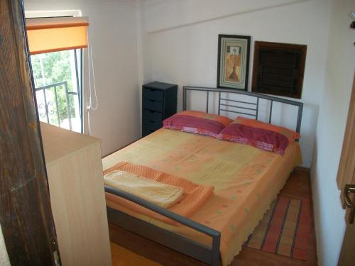a bedroom with a bed in a room with a window at Apartments Luka in Tisno