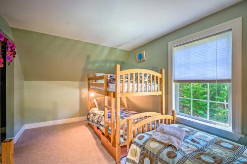 a bedroom with two bunk beds and a window at West Dover Home with Deck, Grill and EV Outlet in West Dover