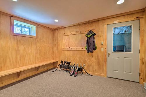a room with wood paneled walls and a door at West Dover Home with Deck, Grill and EV Outlet in West Dover