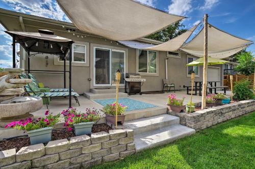 a backyard with a swimming pool and some flowers at 7 Mi to Dtwn Denver Arvada Home with Patio in Arvada