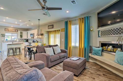 a living room with a couch and chairs and a kitchen at 7 Mi to Dtwn Denver Arvada Home with Patio in Arvada