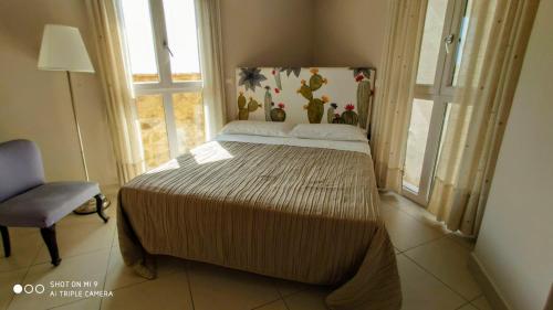 a bedroom with a bed in a room with a window at Torre dei Pirati in Letojanni