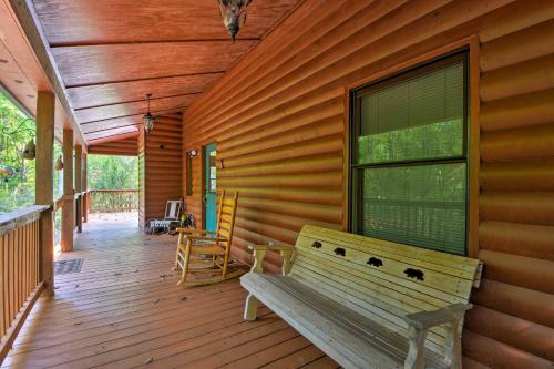a wooden porch with a bench on a house at Andrews Cabin with Game Room and Covered Porch! in Andrews