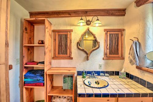 a bathroom with a sink and a mirror at Eclectic Adobe Crestone Cottage with Patio and Yard! in Crestone