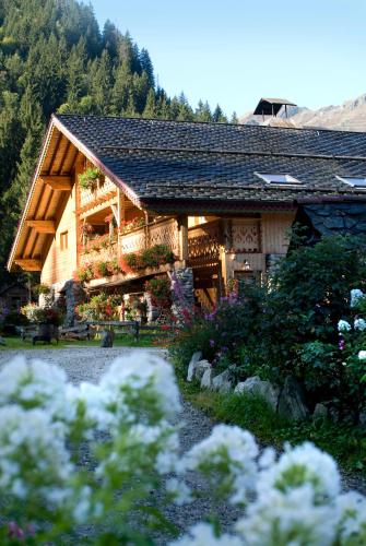 a house with flowers in front of it at Auberge NEMOZ in La Ferrière