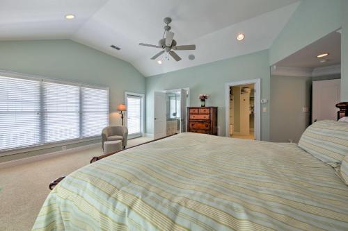 a large bedroom with a bed and a ceiling fan at Manteo Waterfront Resort Home with 30-Ft Dock! in Manteo