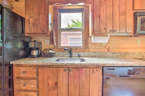 a kitchen with a sink and a window at Mill Spring Cabin Near Parker-Binns Winery! in Mill Spring